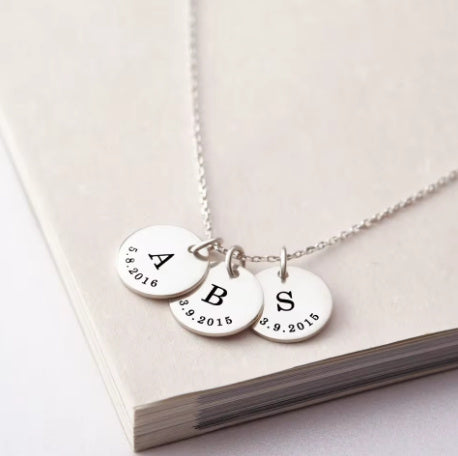 A Rusted Steel Engraved Round Plate Necklace With A Personalized Pet Head Engraving